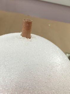 a close up of a white pumpkin with glitter on it