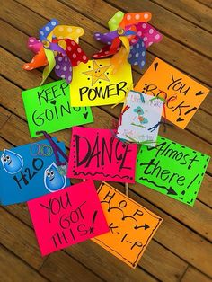 colorful signs with words written on them sitting on a wooden floor