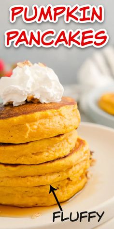 a stack of pancakes with whipped cream on top and the words pumpkin pancakes above it