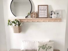 a bench with pillows and some plants on top of it in front of a mirror