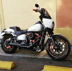 a white and black motorcycle parked next to a building