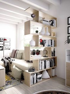 a living room filled with lots of furniture and bookshelves next to a window