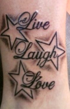 a tattoo that says live laugh love on the side of someone's leg with stars