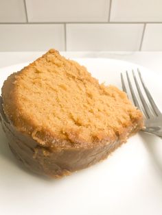 a piece of cake sitting on top of a white plate with a fork next to it