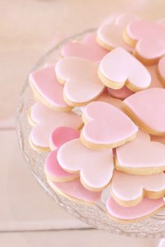 pink and white heart shaped cookies in a glass bowl