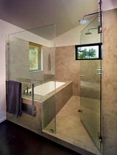 a large bathroom with a walk in shower next to a bathtub and sink under a window