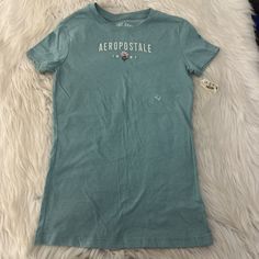 This Aeropostale Women's T-Shirt Is Perfect For Any Casual Occasion. The Solid Blue Color And Crew Neckline Make It A Versatile Piece To Mix And Match With Other Clothing Items. The Short Sleeves And Pullover Closure Make It Easy To Wear Comfortably. Made Of Machine Washable Cotton, This T-Shirt Is A Great Addition To Any Wardrobe. The Center Logo Adds A Touch Of Style To This Basic Piece. Available In Size Small, This T-Shirt Is Perfect For Juniors Who Want A Regular Fit. Aeropostale Shirts Women, Center Logo, Toddler Tops, Boys Top, Logo Color, Journal Inspiration, Mix And Match, Christmas List, Aeropostale