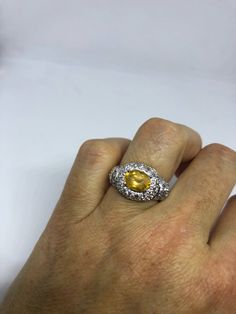 Vintage Golden Citrine Ring Deco 925 Sterling Silver Unusual cut of citrine surrounded by white sapphire Sterling Filigree finished Setting Handmade Size 7 Can be resized by my jeweler for a $10-$20 jeweler's fee All rings are shipped free in the US in a nice gift box. Check out our over a THOUSAND great reviews Engraving is $4 per letter and is not always perfect depending on the piece. It can take a few days if the jeweler is busy. This is payable to Paypal Judithsltd@gmail.com White Gold Citrine Jewelry With Center Stone, Topaz Ring With Yellow Sapphire And Accent Stones, Round Topaz Ring With Yellow Sapphire And Accent Stones, Yellow Sapphire Topaz Ring With Accent Stones, Yellow Sapphire Ring With Oval Shape And Accent Stones, Yellow Sapphire Topaz Ring In Fine Jewelry Style, White Gold Citrine Diamond Ring With Accent Stones, Silver Yellow Sapphire Jewelry For Anniversary, White Gold Citrine Topaz Ring With Center Stone