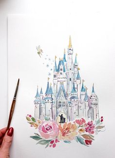 a drawing of a castle with flowers and a person holding a pencil in front of it