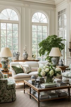 a living room filled with lots of furniture and large vases on top of tables