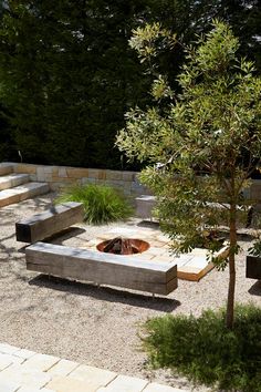 an outdoor fire pit surrounded by stone steps