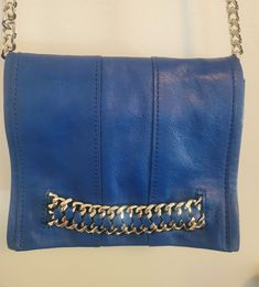 Ramey Brook royal blue leather shoulder or crossbody bag with heavy gold chain strap and details. Nice pop of color for day or night. Strap has a 22" drop. Evening Blue Flap Bag With Adjustable Strap, Elegant Blue Shoulder Bag With Metal Hardware, Blue Leather Flap Bag With Gold-tone Hardware, Evening Blue Flap Bag With Detachable Strap, Blue Shoulder Bag With Metal Hardware, Blue Crossbody Flap Bag With Gold-tone Hardware, Blue Crossbody Bag With Metal Hardware, Formal Blue Bag With Chain Strap, Formal Blue Shoulder Bag With Metal Hardware