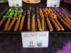 an assortment of halloween candies on display at a vendor's booth for witches and brooms