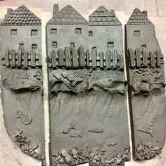 three clay sculptures depicting houses on the beach