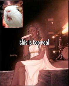 a woman sitting on top of a stage next to a white and black cat with the caption, this is too real