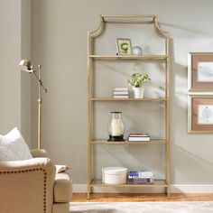 a living room with a couch, chair and book shelf in it's corner