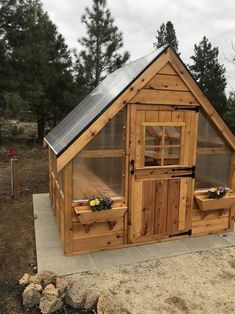 a small wooden building with two windows on the side