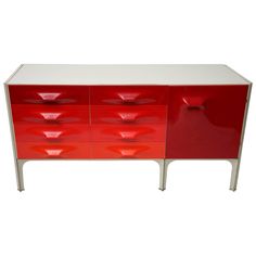 a red and white cabinet with drawers