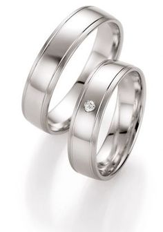 two white gold wedding bands with a diamond