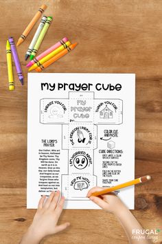 a child's hands holding a crayon pencil over a paper with the words my prayer cube on it