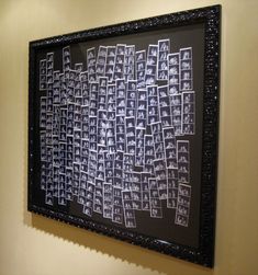 a black and white painting hanging on the wall