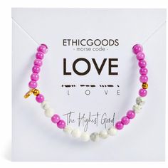 the pink and white beaded bracelet is on display in front of a card that says love