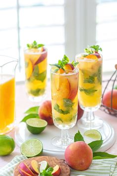 three glasses filled with fruit on top of a table