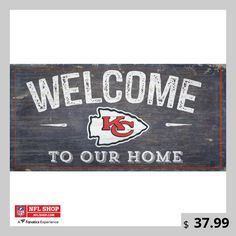 a wooden sign that says welcome to our home with the kansas chiefs logo on it