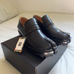 Sasaia Split Toe Loafer. Never Been Used / Worn. They Run Small, So Would Fit If You’re A 9 In Men. ( Maison Margiela Tabi Loafers ) Black Slip-on Loafers With Vibram Sole, Black Loafers With Vibram Sole For Work, Fitted Loafers With Rubber Sole And Flat Heel, Fitted Loafers With Rubber Sole And Round Toe, Leather Slip-on Shoes With Vibram Sole For Work, Fitted Almond Toe Loafers With Rubber Sole, Fall Vibram Sole Slip-on Loafers, Designer Fitted Round Toe Loafers, Designer Fitted Loafers With Round Toe