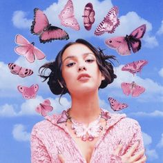 a woman surrounded by butterflies in the sky