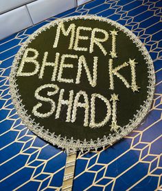 Shaadi Signs or Mehndi Signs! .  These signs are handcrafted  for Traditional Ceremonies. Can be used for Haldi, Mayoon, Dholki, Sangeet, Walima, Mehndi, or Shaadi events.  Shaadi Sign, Dholki Sign, Mehndi Sign.   Materials:  Silk Fabric  Gotta Lace  Gold Thread  Mehndi Decorations or Shaadi Decorations.  Signs that are pre-made are $19.99  Customs Signs are $39.99  Custom Signs take 3-4 weeks to process.  Width: 14 Inches Across  CONTACT SELLER IF YOU WOULD LIKE TO CUSTOMIZE YOUR COLORS and WORDS! NO RETURNS OR EXCHANGES. These are final sale. MUST CANCEL ORDER within 12 Hours. Mehndi Decor At Home Ideas, Shadi Props, Dholki Props, Dholki Decor Home, Mehndi Props, Mehndi Decor At Home, Mehndi Decor Ideas, Dholki Sign, Mehndi Signs