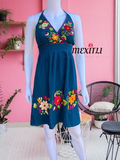 "Hand embroidered Mexican Halter dress. Made out of manta, 100% cotton. Each dress is unique, the embroidery may be slightly different from the one pictured. Color- Teal / multicolored embroidery Dimensions: Small/ Medium Bust- 41\" Hips-50\" Length- 36\" Large Bust- 45\" Hips- 52\" Length- 36\" 🧵Made in Chiapas, Mexico. 🧺Care Instructions: We recommend hand washing, air dry. 📲Please feel free to message me with any questions regarding sizing and fit. 📷Additional photos can be provided upon Traditional Sleeveless Cotton Embroidered Dress, Traditional Sleeveless Embroidered Cotton Dress, Green Cotton Dress With Intricate Embroidery, Folk Style Cotton Dress With Embroidered Neckline, Folk Style Embroidered Cotton Dress, Multicolor Cotton Embroidered Dress With Border, Blue Cotton Embroidered Beach Dress, Spring Cotton Dress With Embroidered Border, Blue Cotton Folk Dress