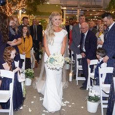 the bride and groom are walking down the aisle