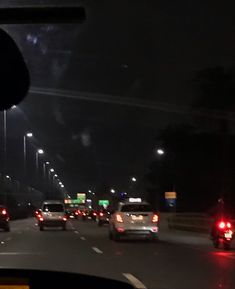 cars driving down the highway at night time