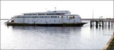 a large white boat floating on top of a body of water