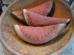 three pieces of watermelon sitting in a bowl