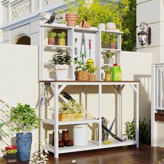 a shelf filled with potted plants on top of a wooden floor next to a white fence