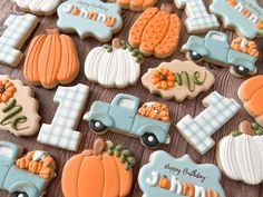 decorated cookies are arranged on a table with pumpkins and other items in the background