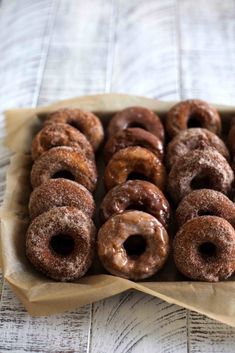 a box filled with lots of donuts covered in icing