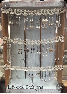 a display case with lots of earrings on it