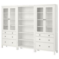 two white bookcases with drawers on each side