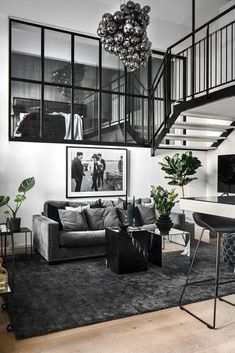 a living room filled with furniture and a spiral staircase