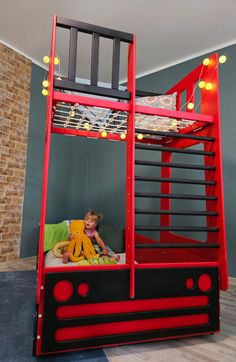 a child's bedroom with a bunk bed made out of red and black furniture