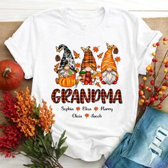 a white shirt with the words grandma and three gnomes on it next to some pumpkins