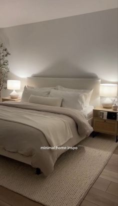 a bedroom with white bedding and pillows