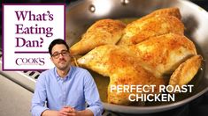 a man standing in front of a pan filled with chicken