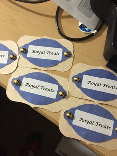 four royal treats tags sitting on top of a desk