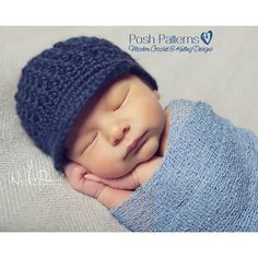 a newborn baby wearing a blue knitted hat