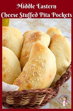 a basket full of cheese stuffed pita pockets with sesame seed sprinkles