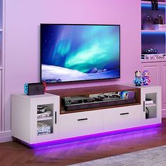 a living room with purple walls and a flat screen tv